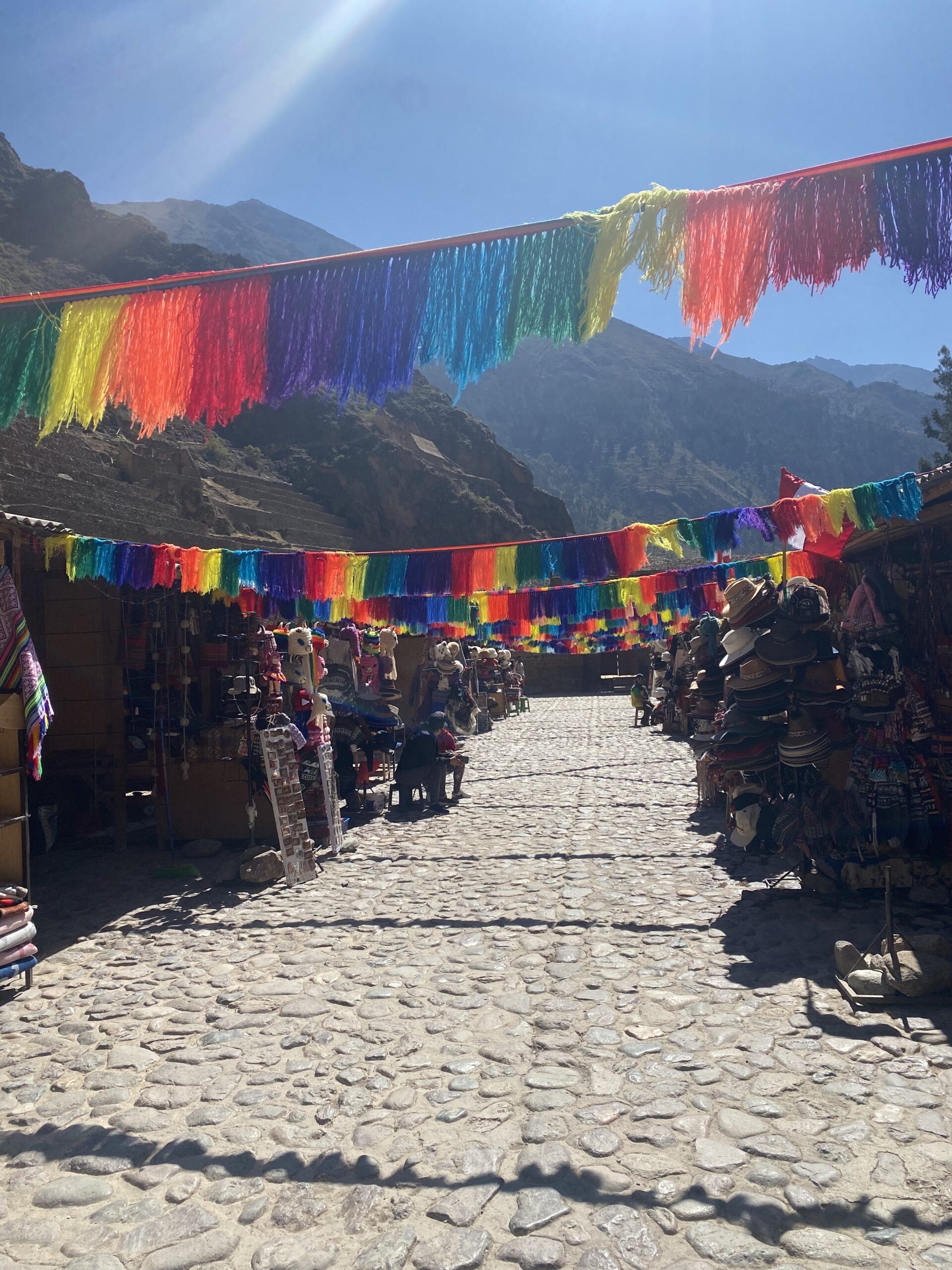 Bancarelle del mercato artigianale di Ollantaytambo decorate con festoni colorati